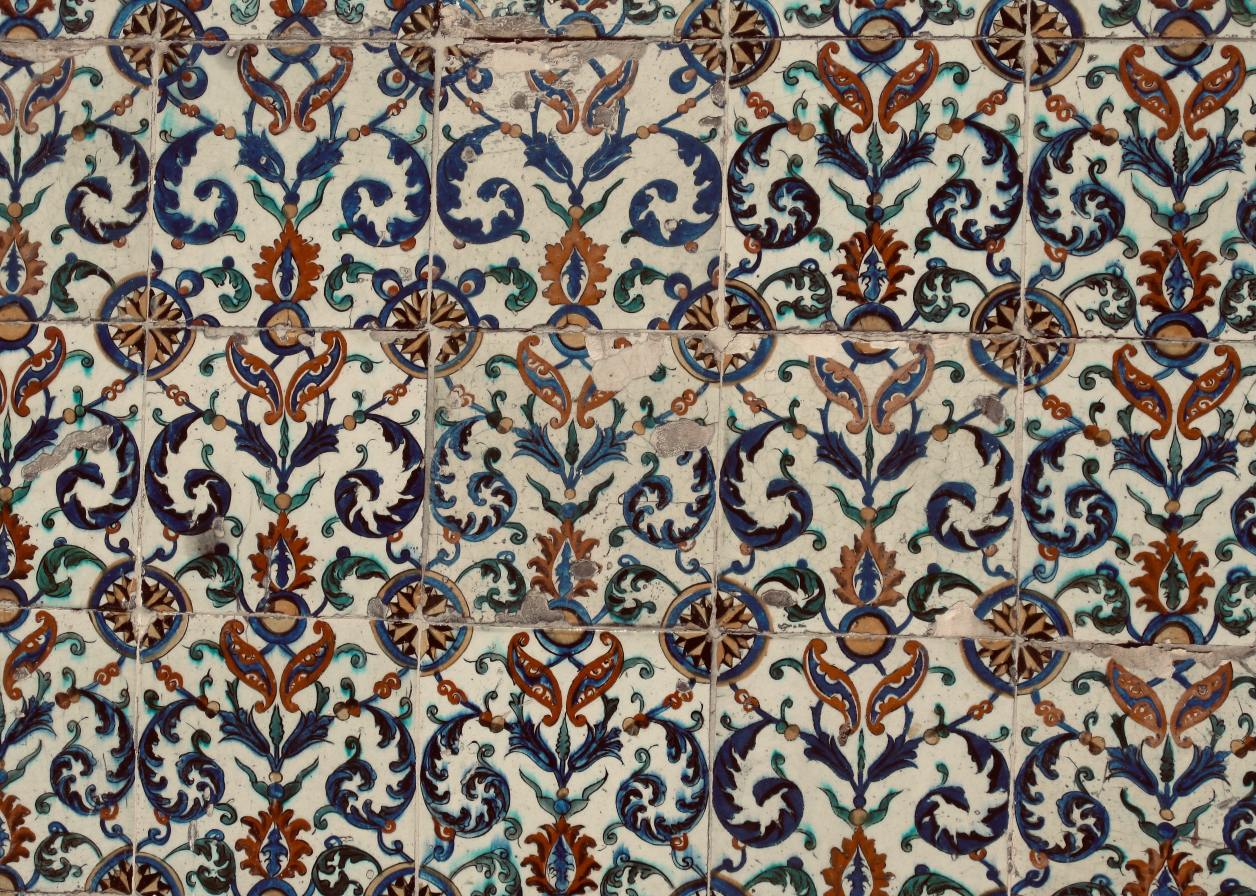 A handpainted tile pattern in deep blues and terracotta — a quiet visual rest between thoughts.